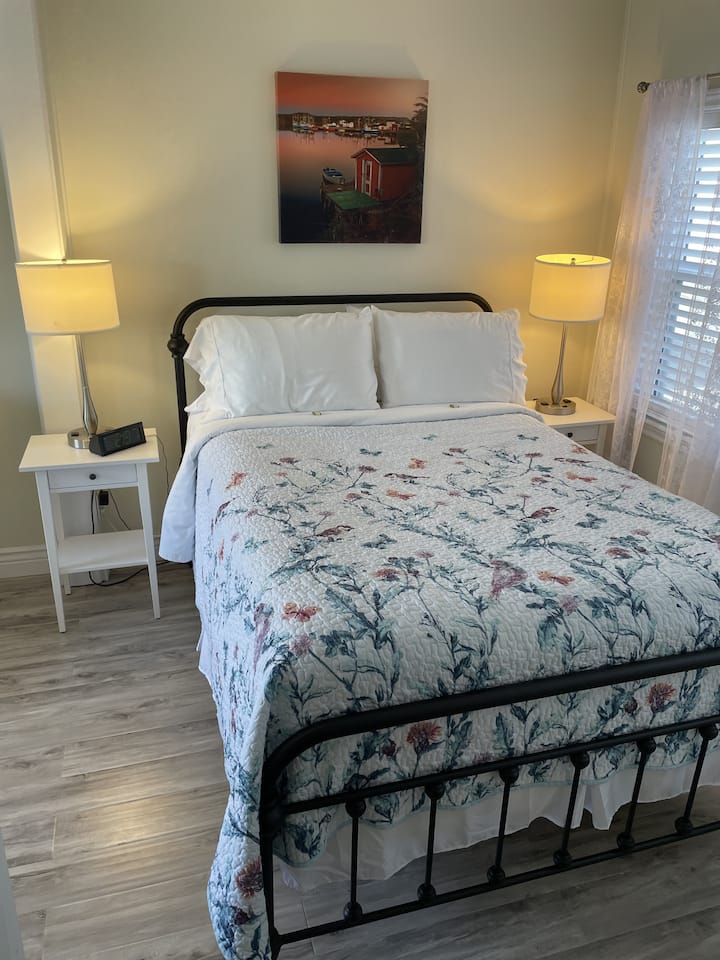 The primary bedroom includes double bed, plenty of storage, room-darkening blinds, and a comfy sitting room, with harbour views, to relax or enjoy a cup of tea in the morning.