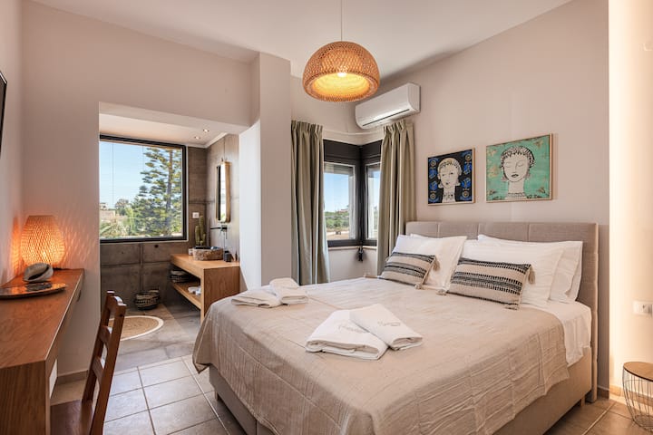 Cozy air-conditioned bedroom with King-size bed, ensuite bath, and 32” HDTV.