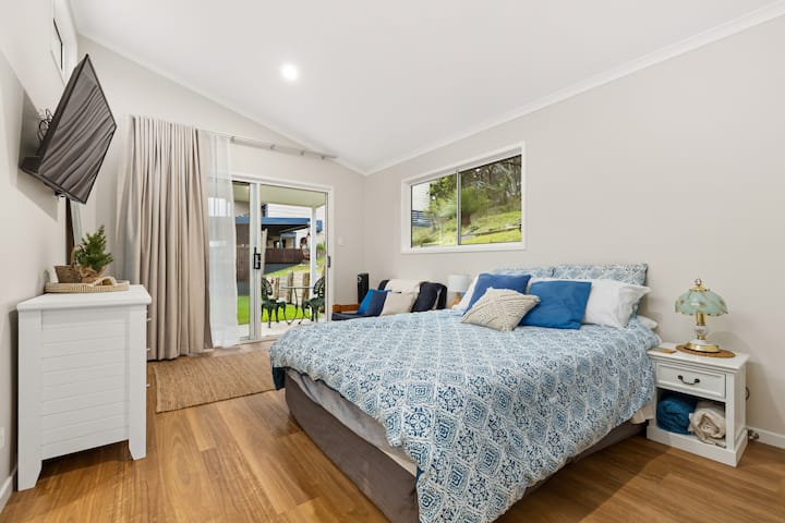 Bedroom 3 View: Showcasing the sliding glass door leading to a private patio, this perspective highlights the room's exclusive and serene outdoor area.