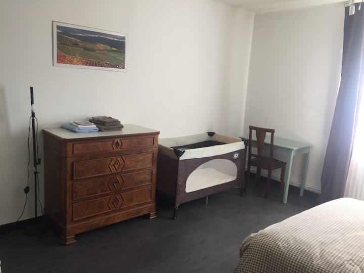 bedroom floor 2nd level, garden side, baby bed, small table.