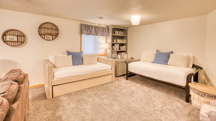 At the west end of the lower level family room, you will find 2 beds / kids area with some toys and games.