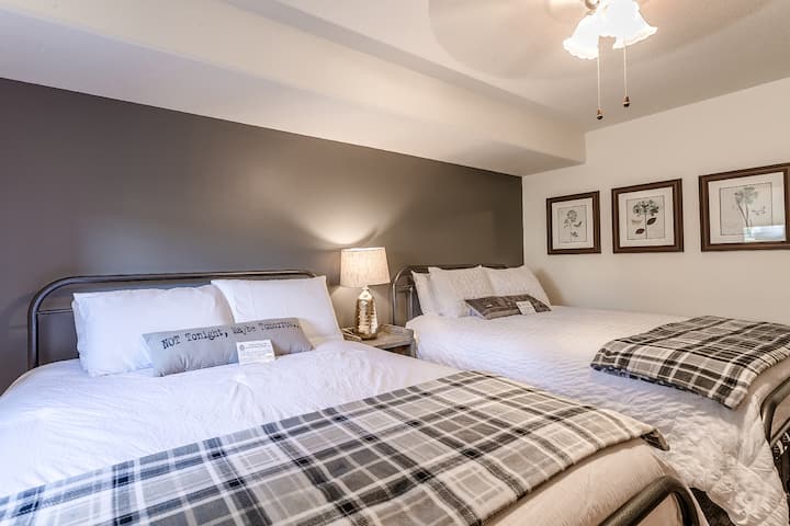 The larger bedroom downstairs has a comfy queen bed with an amazing mattress, and a twin bed which can be used like a sofa as well.  Room also has a desk.
