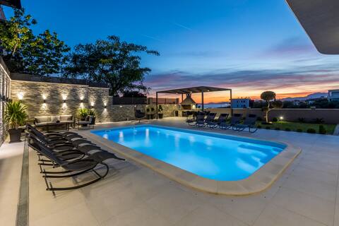 Coastal Luxury | Heated Pool & Steps to the Beach