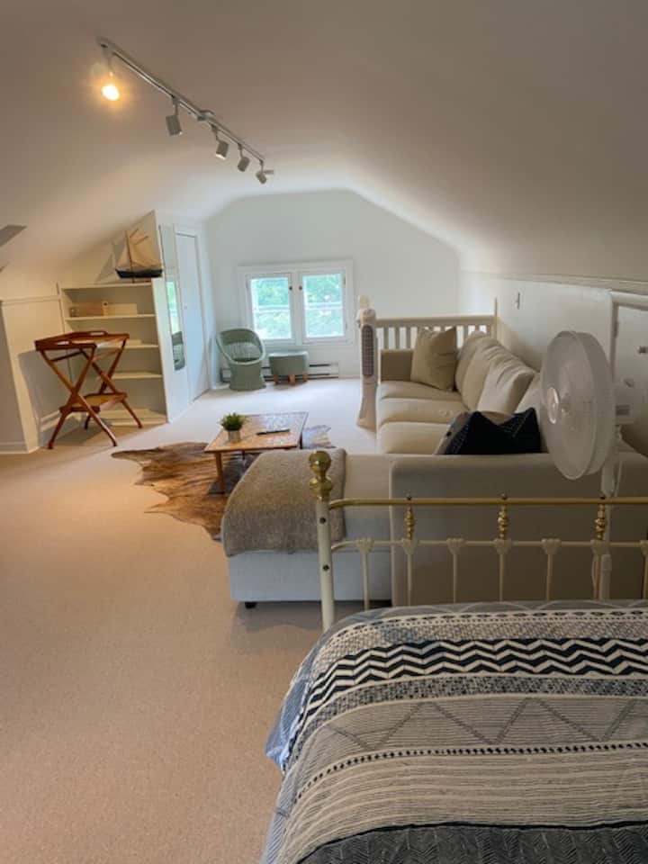 Attic Bedroom with 2 single beds, full size sectional and 65 inch smart TV