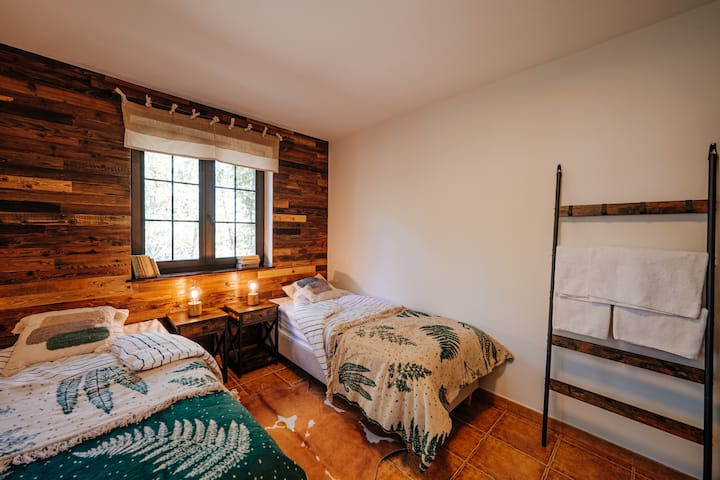 Bedroom № 1 with two bed setup options: 1 double bed or 2 single beds. With a clothes hanger, dresser, and towel rack. Sun-blocking blinds, mosquito nets. 
Bedroom № 1 with two bed options: 1 double or 2 single. 