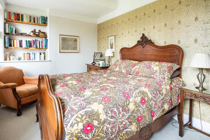 Master bedroom with soft William Morris bedding