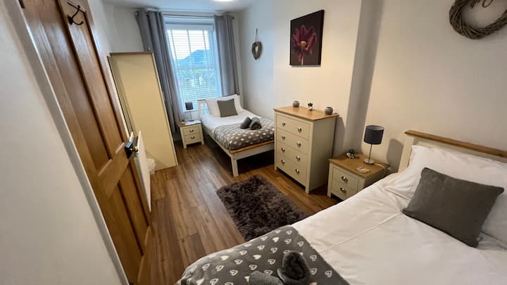 Bedroom 2 - A Twin bedded room with spectacular views over Keswick and Catbells ridge. Sturdy wooden single beds with comfortable mattresses, bedside cabinets, chest of drawers and a wardrobe. A great room to sit and watch the Catbells sunset.
