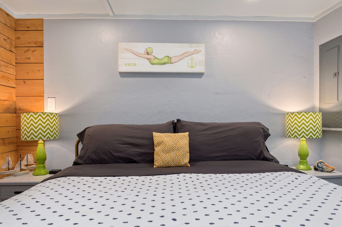 King bed with smart television and charging stations at each bedside
