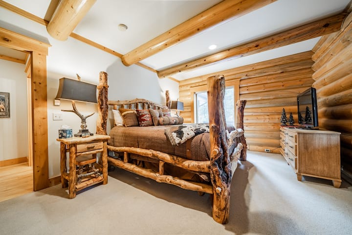 This view is of the downstairs king bedroom, just off the kitchen. We love the rustic log furniture. 