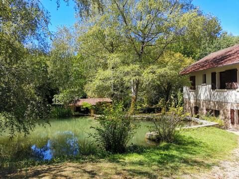 Former watermill in a green valley