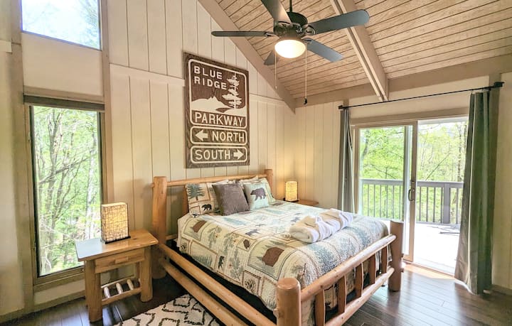 Primary Suite: Spacious room with very high ceilings, lot of natural lighting and private access to the rear deck.   Plenty of storage two with a closet and dresser.

Fun Fact: The Blue Ridge Parkway sign was hand painted by the owner  - Bryan!
