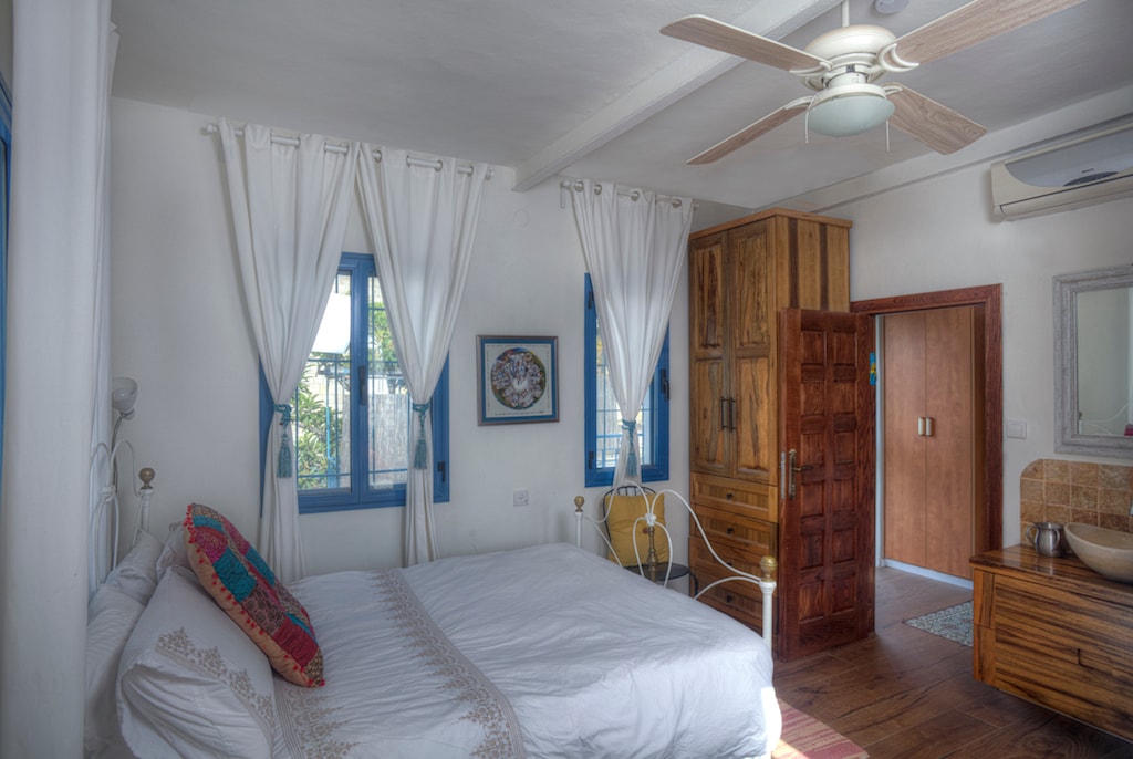 This bedroom is upstairs and features a double bed plus a single with pullout. The room can sleep up to four and has an ensuite bathroom with toilet and sink. A bathroom with shower is adjacent and is shared with the second upstairs bedroom.