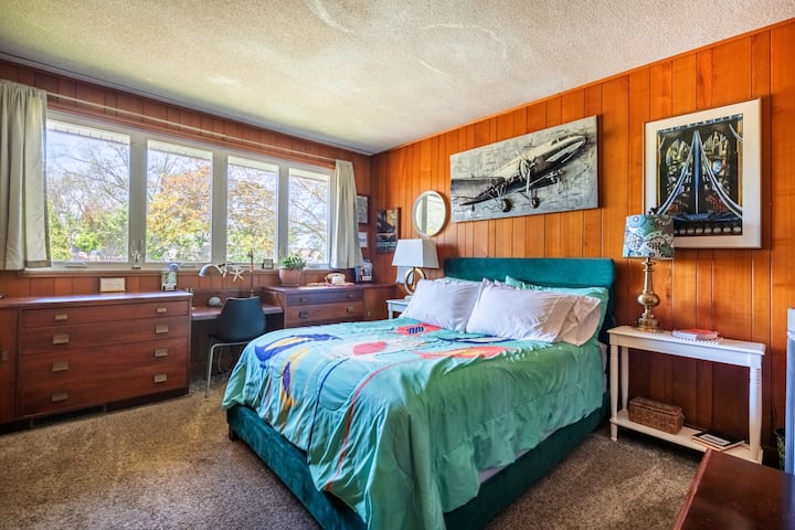 Guest Room 1 offers a queen bed, dresser, closet and panoramic views from the spacious windows.