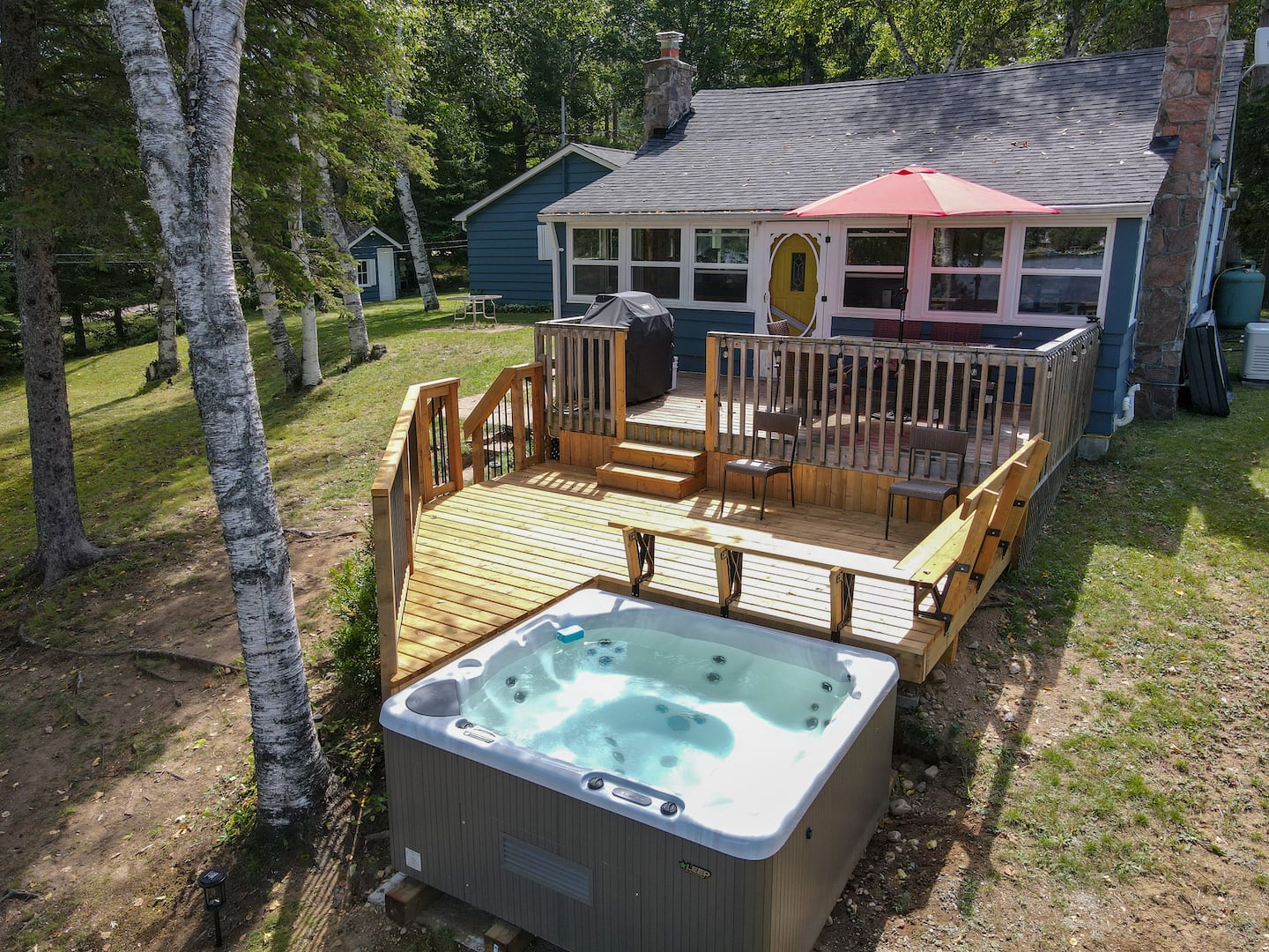 Hot tub on the deck overlooking the lake at sunset