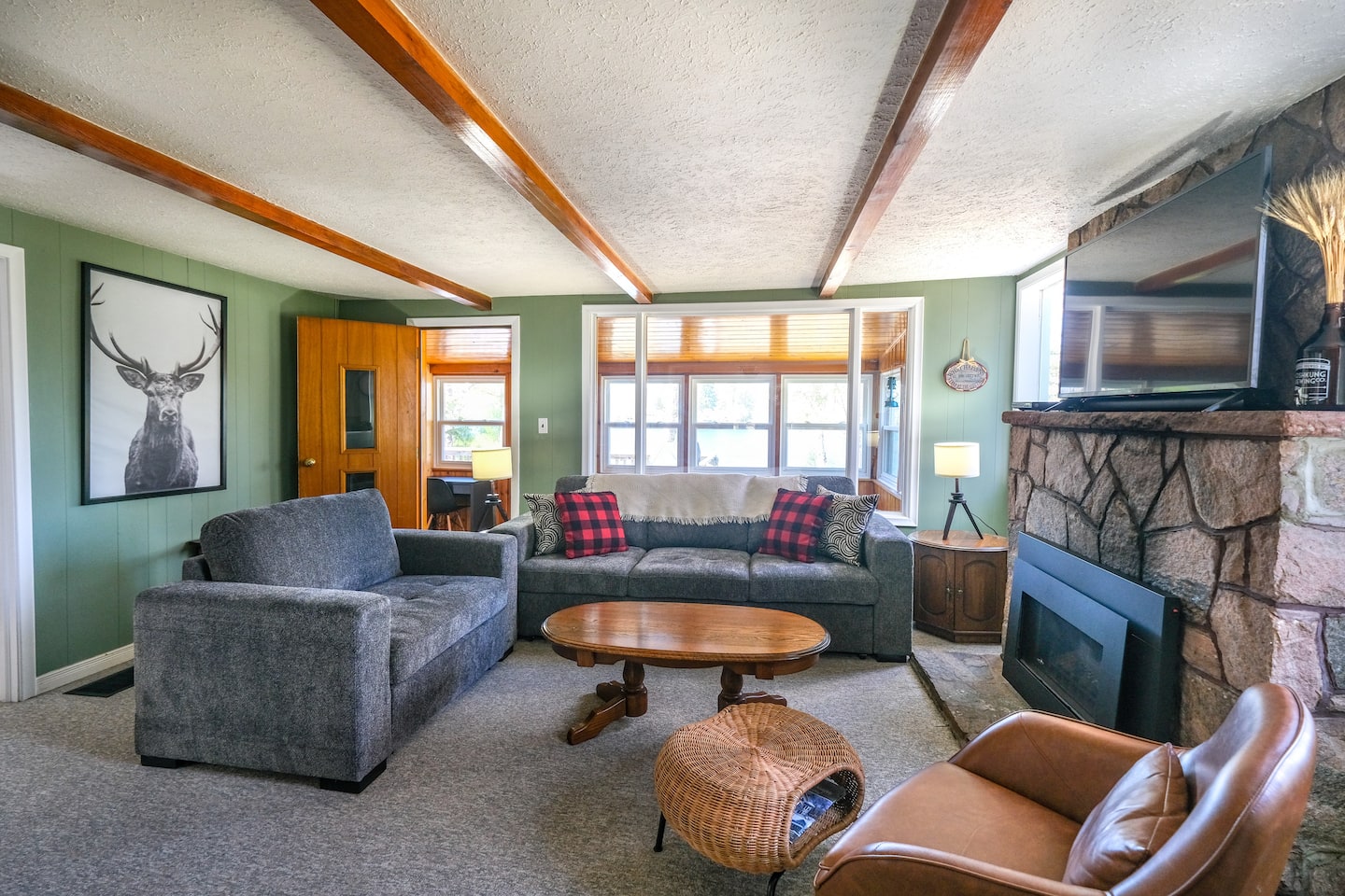 Bright living room with large windows and lake view