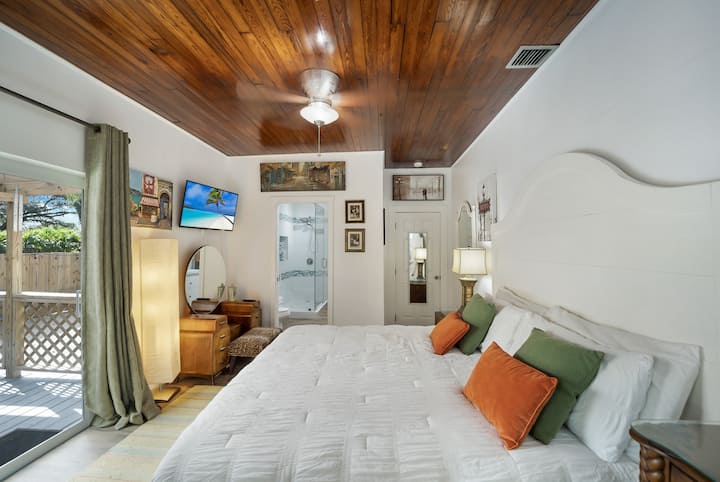 Master  bedroom with king size bed has a private covered deck and has a direct access to the master bathroom.