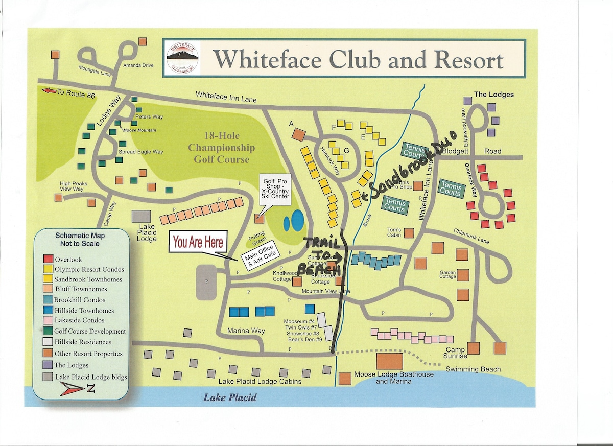 A colorful map of the Whiteface Club and Resort is shown, highlighting the layout of the area, including the golf course, beach access, and surrounding lodges. Key features such as trails and locations are marked for easy reference, providing a helpful guide for guests.