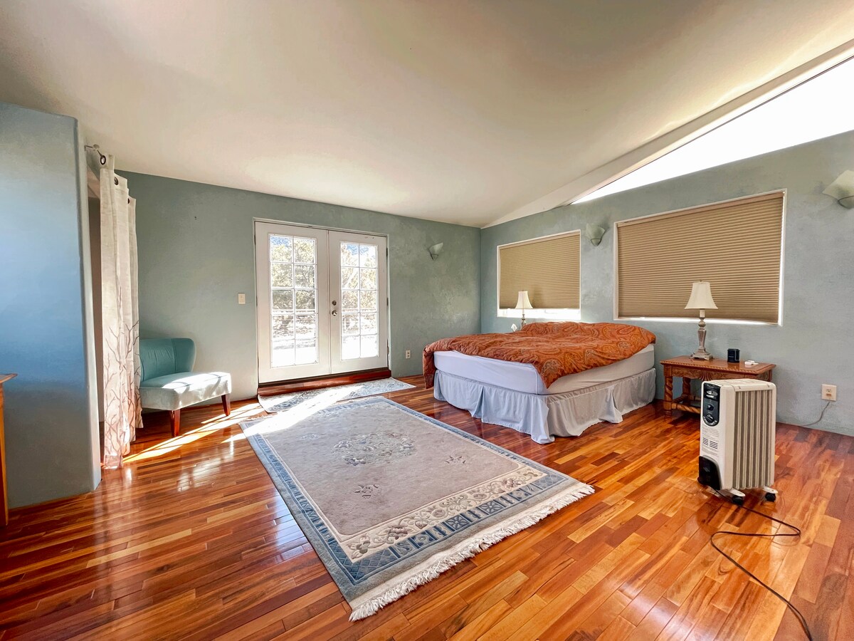 Master Bedroom with A Private Deck,  Amazing Wood Floors, Queen Size Bed along with Sacred Geometry Windows