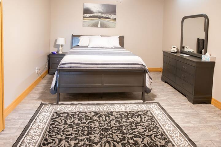 "The open road" theme bedroom has a queen bed, in the basement 