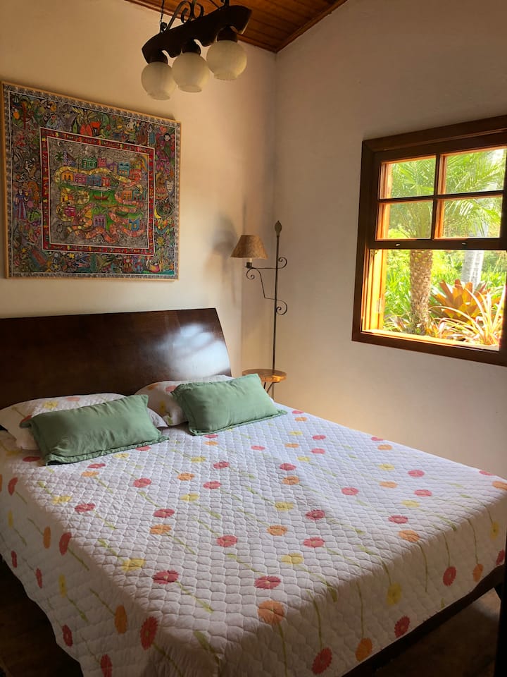 חדר שינה כפול עם נוף לחלון הגינה. 