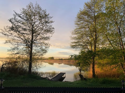 Haus am See with jetty, boat, fireplace and sauna