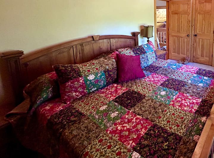 Comfy king bedroom on the upstairs level has a walk in closet and shares a bath with the bedroom next door.