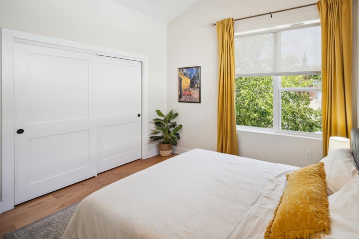 El segundo dormitorio es luminoso y espacioso y viene con una cama tamaño queen, un espejo de cuerpo entero y un baño privado.