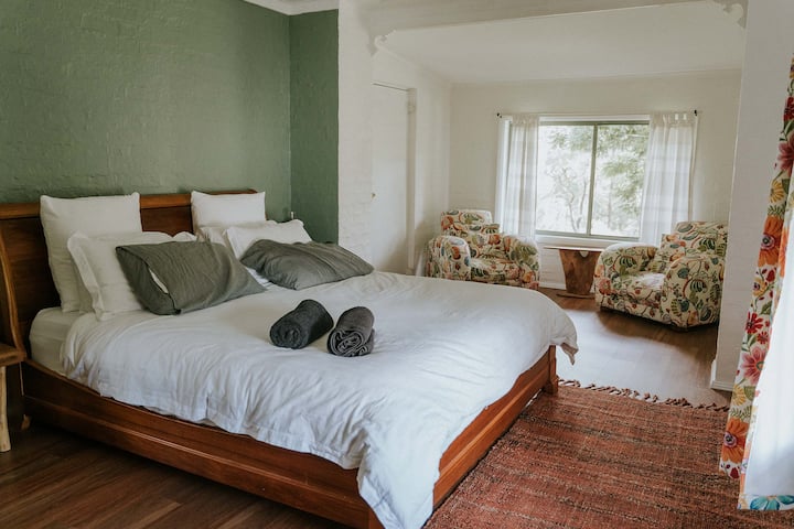 Main bedroom with King Size Bed at Valley Views.

It is possible to move these chairs and set up a queen size mattress.

Also a work desk with monitor can be set up in either bedroom on request for workcations