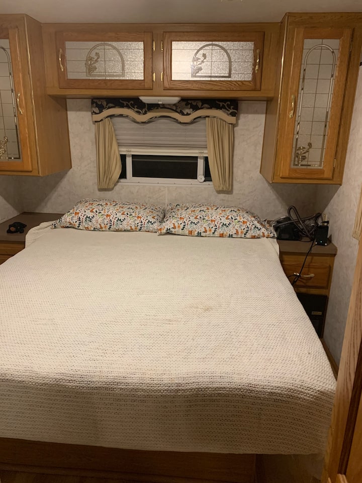 Queen size bed along with built-in cabinets for storage. 