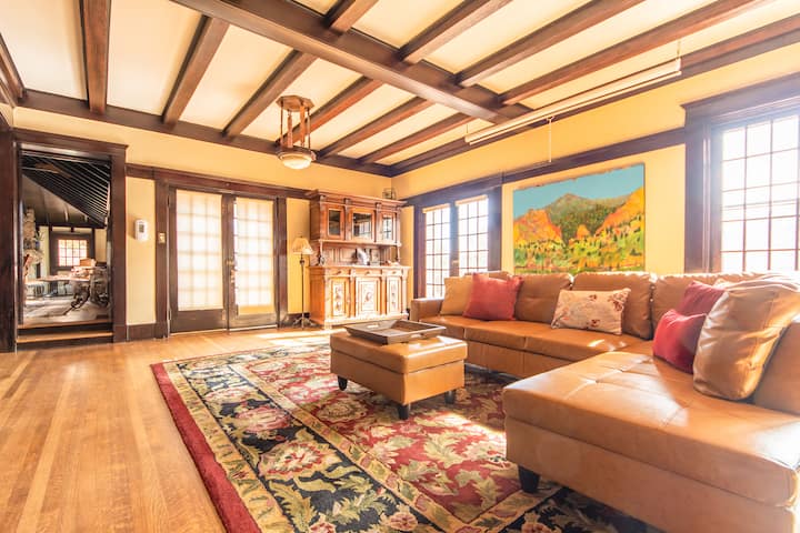 Access the dining room, the front dining patio or the front patio overlook via the living room. 
This is the main floor living room that can also be reconfigured for a YOGA space