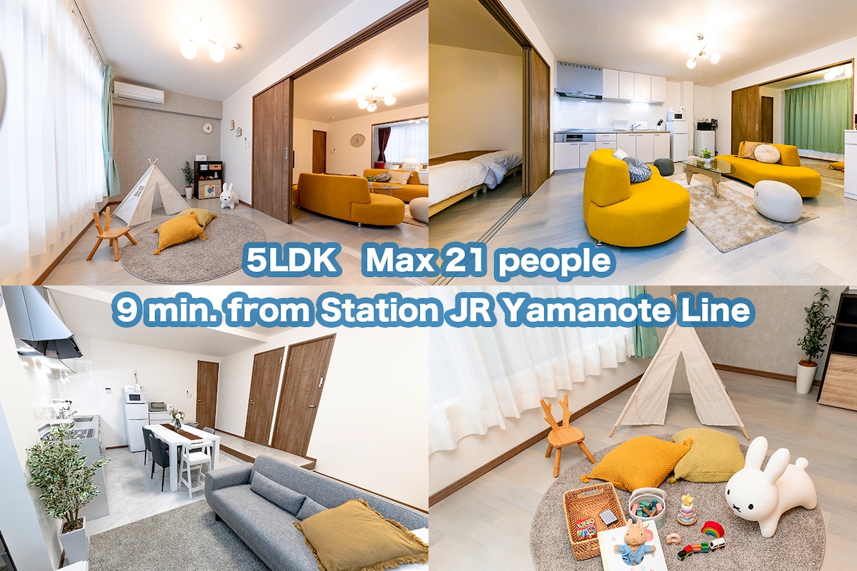 This spacious living area accommodates up to 21 guests, featuring a combination of comfortable seating and playful decor. Bright yellow cushions and a cozy play tent create an inviting atmosphere. Ample natural light is let in through large windows, enhancing the room's open design.