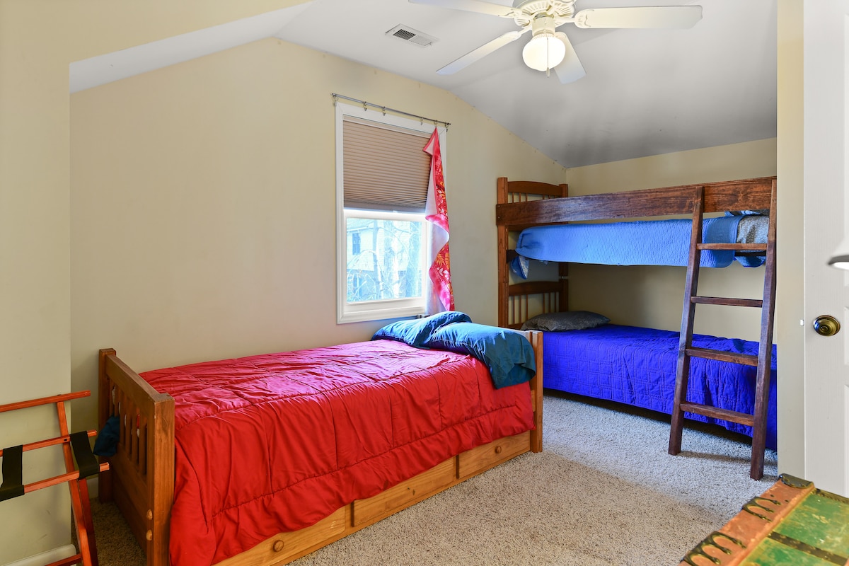 Bunk bed room with 3 twins plus a trundle bed (4 total) connected to bathroom.