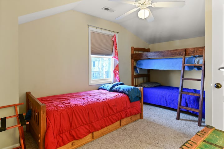 Bunk bed room with 3 twins plus a trundle bed (4 total) connected to bathroom.