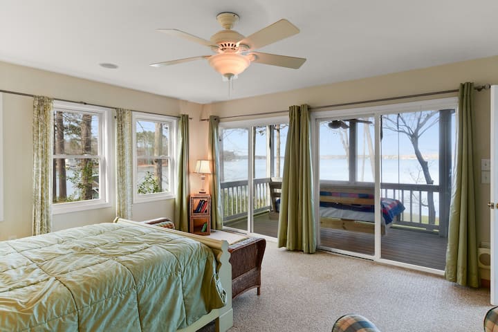 Master bedroom has views from 2 sides, TV and full bath.  Hanging bed outside in a fully screened in room.