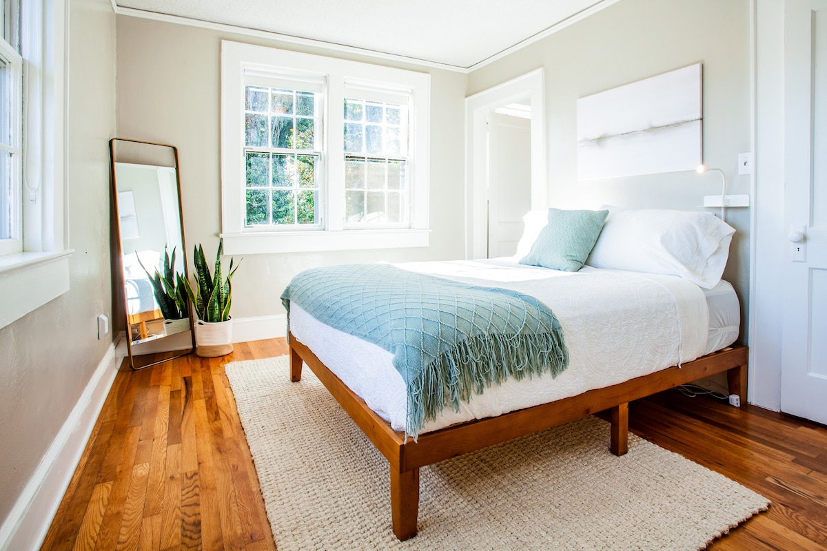 Bedroom number one, AKA the front bedroom, directly off the living area, smallest in size but incredible mountain views, a large walk in closet and full bath with a vintage shower/tub combo.