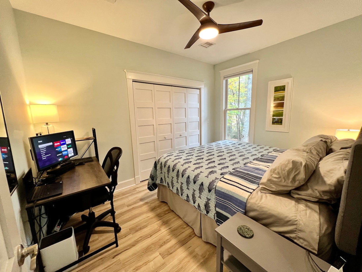 Primary bedroom, with king size bed, double closet, dresser, desk, and monitor that can be used as a second monitor for your laptop, or a TV screen with our Roku bar (and all the streaming apps).