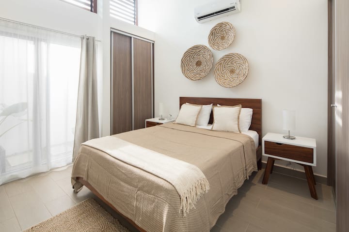 Master bedroom with queen size bed, private bathroom and large closet.