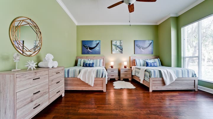 Embrace the sun in this bedroom, where large windows usher in natural light, awakening you to a new day filled with possibilities.