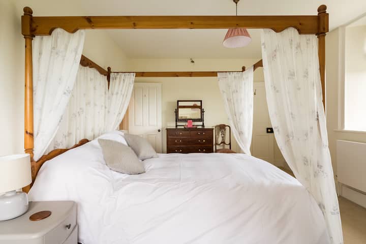 Garden View, another king sized four poster with double aspect views over the gardens and beyond
