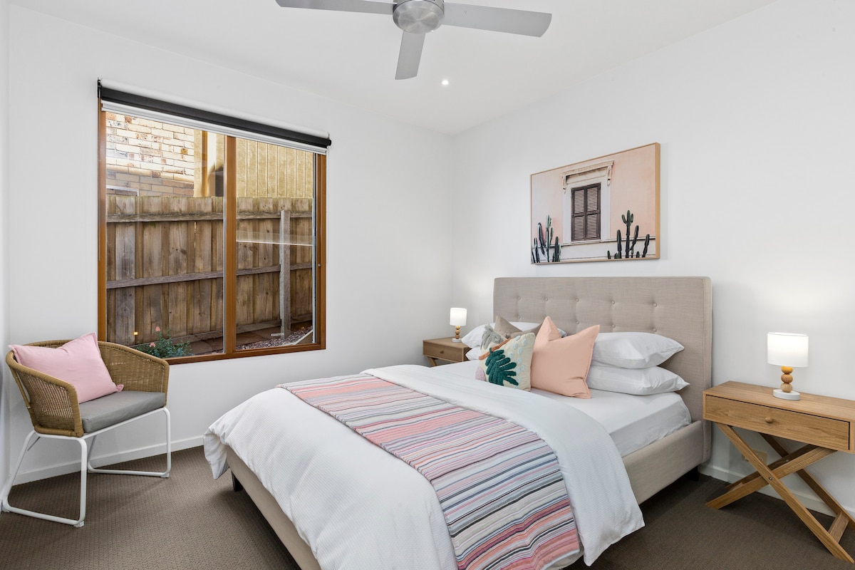 Spacious Queen bedroom with ceiling fan, beautifully appointed with hotel quality sheets and bath towels. 