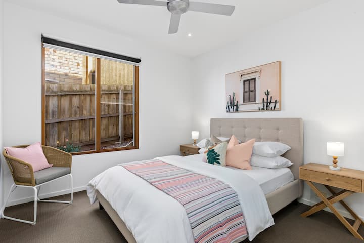 Spacious Queen bedroom with ceiling fan, beautifully appointed with hotel quality sheets and bath towels. 