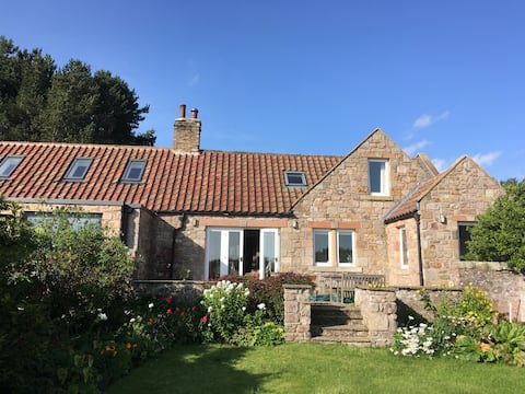 Attractive, uniquely-situated stone cottage.