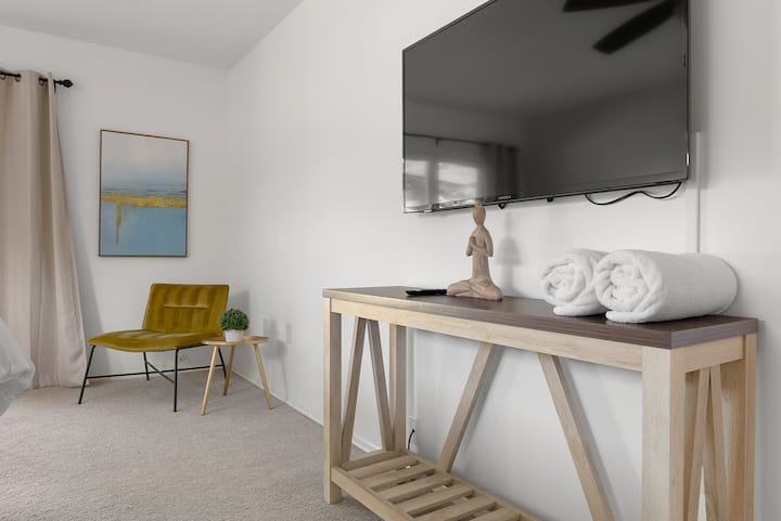 Master bedroom with 50" smart TV and sitting area