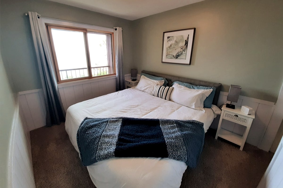 Main floor bedroom with king sized bed and closet. Fall asleep to the waves!