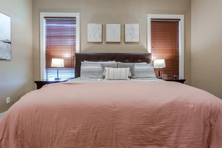The master bedroom has a king bed and a large smart TV, as well as a huge closet, and a gorgeous bathroom with large tub and walk in shower. 
