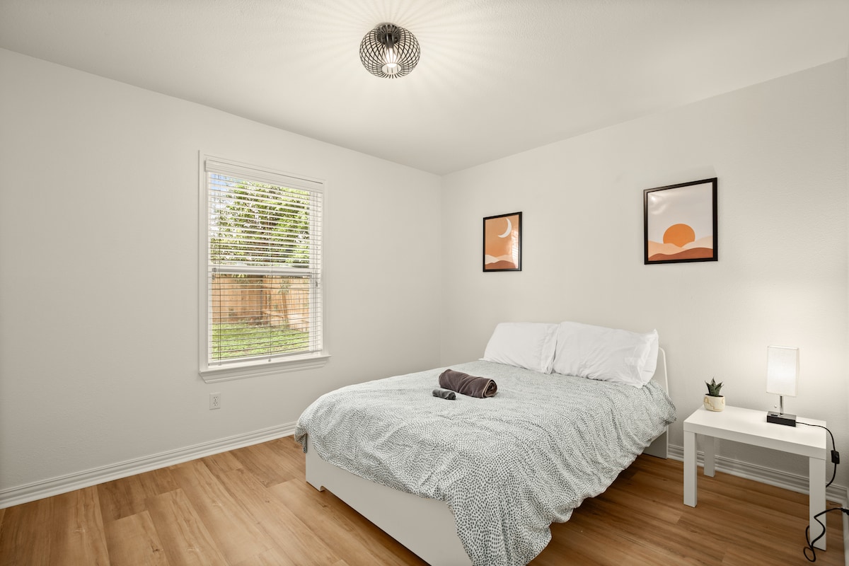 Second Bedroom. Full bed with side table, USB charging lamp, and lots of storage space in the closet 