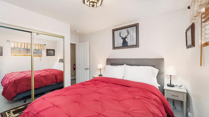 Queen Bedroom - Includes a 32" Smart TV and full use of the closet.  There are 2 lamps with usb charging outlets and a white noise sound machine .   Both bedrooms of the cabin are upstairs.