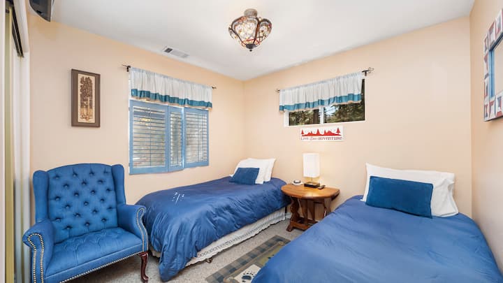 Twin Beds - This room includes a 32" Smart TV and a wireless cellphone charger on the base of the lamp and a white noise sound machine.  Upstairs of the cabin.
