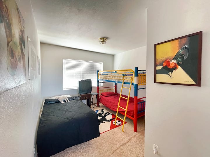 Bedroom # 2/ A well Lit Bedroom with a Large Window with 3 beds with a Closet 