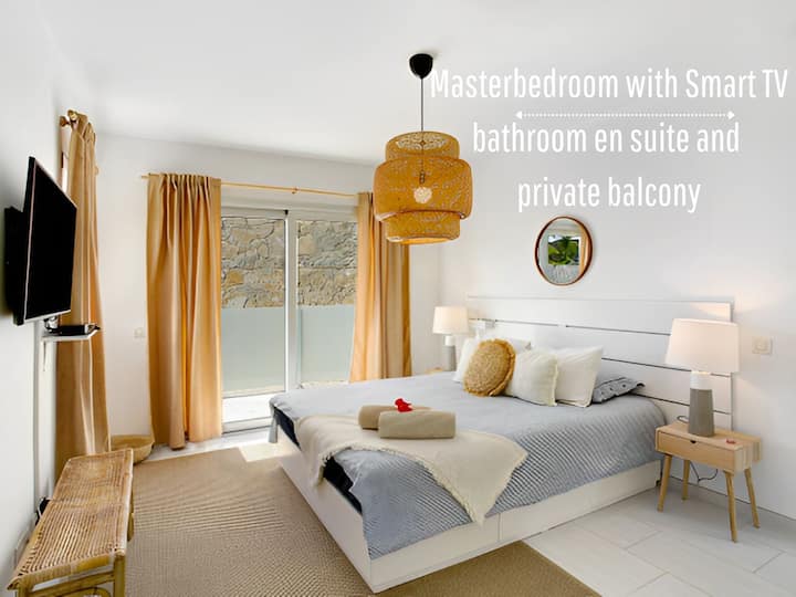 Dormitorio principal con acceso al balcón y dormitorio principal en suite con Smart TV y aire acondicionado